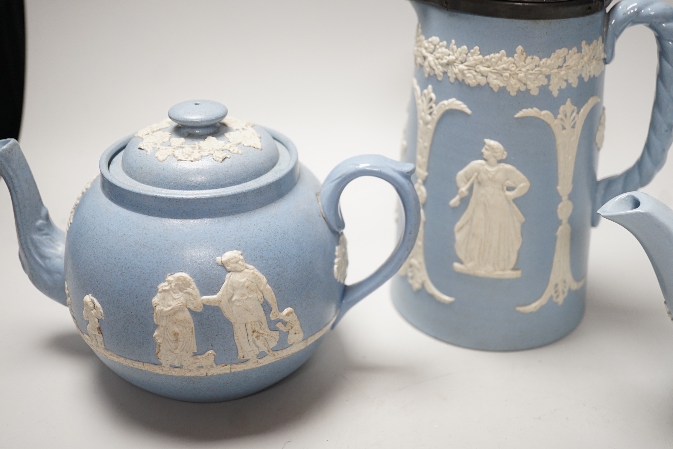 A group of Wedgwood and Wedgwood-style jasperware teapots and jugs.